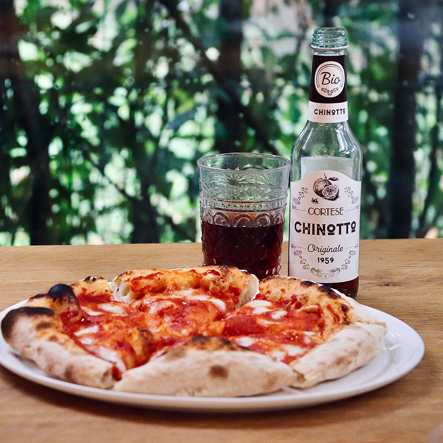 Cortese Chinotto with a glass and pizza