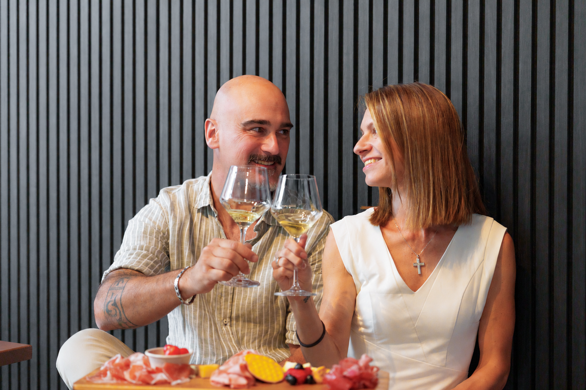 Alice and Gabriel sharing wine and an antipasto board, founders of Troppo Buono Imports